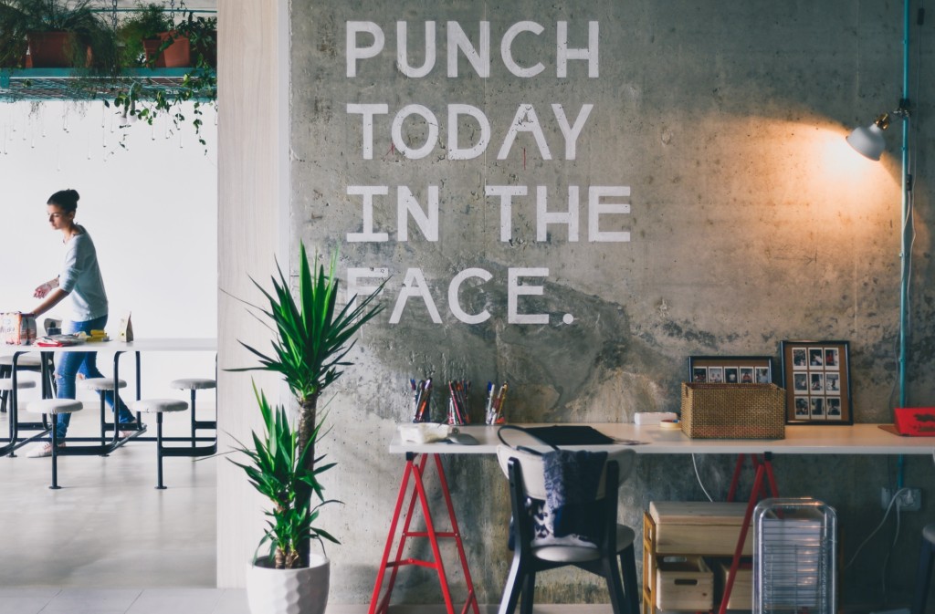 This is a photograph of an office wall that says, 'Punch today in the face'. It's representative of stress.